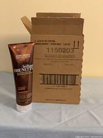 Box of 6 John Frieda Brilliant Brunette Shampoo tubes with one shampoo tube outside the box