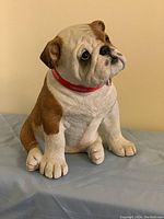 Front view of English Bulldog statue showing facial features and collar.