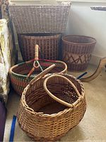 Five assorted Italian baskets displayed together showing variety of shapes and weaving styles.