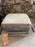 Closed beige carrying case for Revere reel-to-reel tape recorder with latch and handle visible