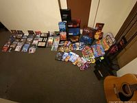 Full layout showing extensive collection of video editing software DVDs, CDs, and storage rack, with visible guitar body excluded from sale.