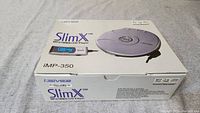 The original retail box showing the iRiver SlimX iMP-350 MP3 WMA CD Player and details including USB compatibility.