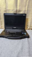 Front view of Panasonic Toughbook CF-53 laptop with screen open, showing keyboard and screen area.