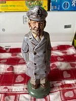 Full view of ceramic sailor liquor bottle figurine standing on a rounded base, showing complete outfit and stance.