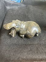 Side view of hippo soapstone carving showing detailed face and partial body