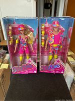 Front view of boxed Barbie and Ken dolls from Barbie The Movie in colorful rollerblading outfits.