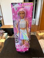Front view of Barbie Estrella The Pop Star doll in original packaging showing holographic skirt and glitter top with microphone accessory.