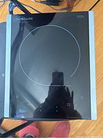 Top-down view of the Frigidaire Gallery induction hotplate showing the cooktop surface, touch controls, and power cord.