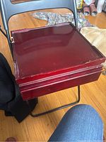 Closed wooden box storage container for multi-game set showing red-brown finish and square shape