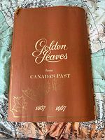 Front cover of the large vintage book titled 'Golden Leaves from Canada's Past 1867-1967' showing embossing and rolled edges.