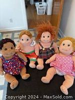 Front view of 4 vintage TY Beanie Kids on the floor showing all characters and their details, tags visible