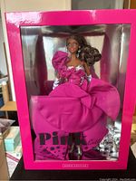 Front view of Barbie doll in original pink box, showing full gown and packaging with Pink Collection branding.