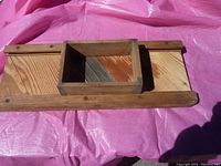 Photo of full vintage wood cabbage slicer showing entire rectangular base with two metal blades and attached wooden box for pressing cabbage.