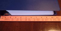 Closed large binder shown next to a ruler approximately 11 inches wide indicating thickness of binder.