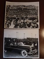 Two black and white photos: top photo of large seated audience inside stadium or auditorium; bottom photo shows Queen Elizabeth II and a man in a dark convertible car waving to the crowd outdoors.