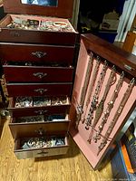 Front view of open cabinet showing multiple drawers and side pendant storage