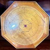 Full view of the vintage bentley's crokinole board, showing the octagonal wooden design and scoring rings