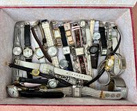 Overhead shot of all watches laid in a decorative box