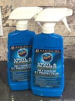 Photo of two blue 16 fl oz spray bottles of Meguiar's Marine & RV Vinyl & Rubber Cleaner and Protectant.