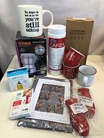 Full lot showing mugs, coffee grinder, Cafiza cleaner, oil sprayer box, tea towel, and silicone holders.