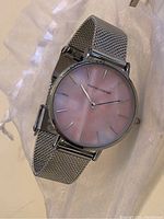 Front close-up view of the Marcus Rosevelt watch showing pink dial and silver mesh band