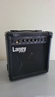 Front and side view of black Laney Hardcore Max guitar amplifier showing control panel with knobs, input jack, and power switch.