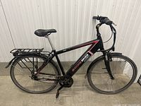 Full side view of black Shocke Bikes Surge S adult electric bike with no battery, showing frame, wheels, rear rack, and fenders.