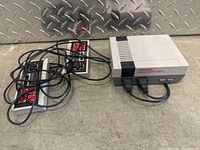 Photo of Cool Baby Family Computer System console with two wired controllers.