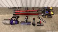 Overall contents laid out: main unit, extension wands, cleaning heads, and attachments
