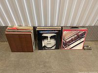 Three stacks of vinyl records shown from the front, with clear view of Elton John and The Beatles albums on top.