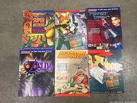 Six guides and magazines laid out on floor showing all cover art