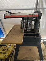 Full view of Craftsman radial arm saw with 12 amp motor on base and wooden table surface.