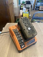 Front angle of the Ridgid battery charger with battery pack attached.