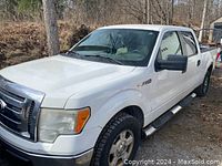 Front-left three-quarter view showing white exterior, chrome grille, black side steps and newer tires