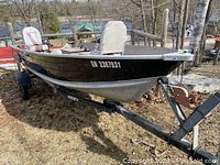 Boat mounted on Wiscot trailer, view from port bow showing hull, registration number ON 2367931