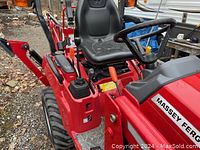 Operator station with seat, steering wheel, and control levers