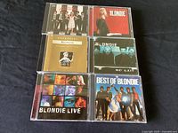 Seven Blondie CD jewel cases laid out showing front covers with artwork and band photos
