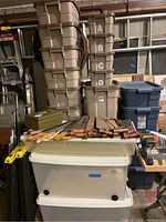 Overall view of beige and white bins on bench, tools placed on top not included