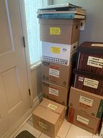 Stack of six labeled boxes containing the books as per seller's description