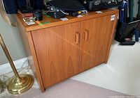 Side view showing solid teak wood grain panel of office cabinet.