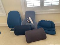 Wide shot of six Obus Forme back cushions including large and small shapes and cylindrical lumbar supports