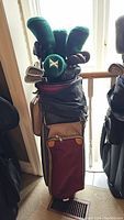 Full view of golf bag filled with clubs and headcovers