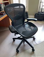 Front quarter view of chair showing mesh seat and back