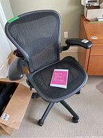 Front-right perspective showing seat, mesh back, right armrest and casters