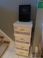 Four boxes labeled for history books, stacked with a black slipcase book on top titled 'The Second World War'.