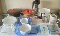 Full view of lot items including cookware, baking dishes, pitchers, and measuring tools.