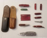 Full lot showing all pocket cutters, multi-tools, and two leather sheaths