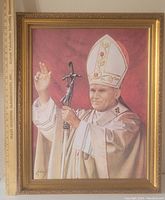 Full view of the framed wall art depicting Pope John Paul II in white robes and mitre, holding a staff with crucifix.