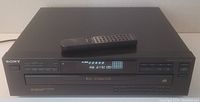 Front view of Sony 5-disc CD player with remote control resting on top.