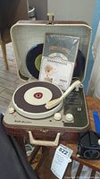 Photo of RCA Victor record player with 45 size vinyl records including Gramophone branding